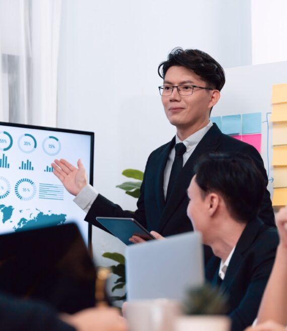 Confidence and young asian businessman give presentation to promote harmony.
